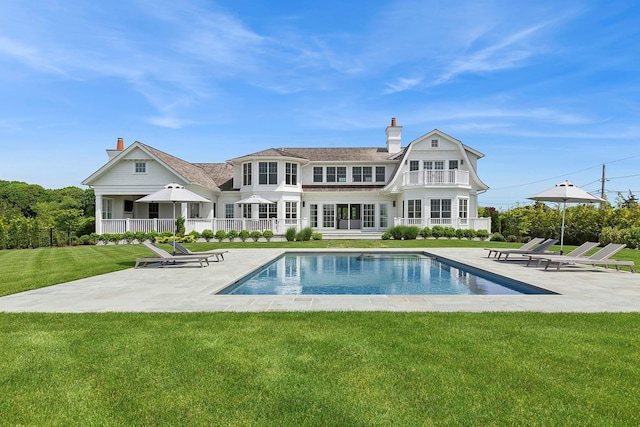 1 Fiske Ave, Westhampton Beach, NY 11978 - rear view of house featuring a chimney, a patio, and a balcony