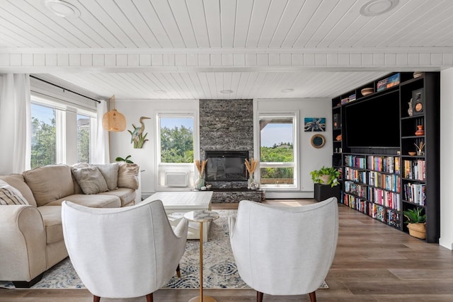 8 The Fairway, Oak Beach, NY 11702 - living room with a wood ceiling with exposed beams, plenty of natural light, a fireplace, wood finished floors, and baseboard heating
