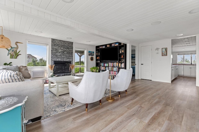 8 The Fairway, Oak Beach, NY 11702 - living room featuring a wood ceiling with exposed beams, light wood-style floors, and a fireplace