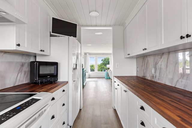8 The Fairway, Oak Beach, NY 11702 - kitchen featuring butcher block countertops, range hood, black microwave, white electric range oven, and backsplash