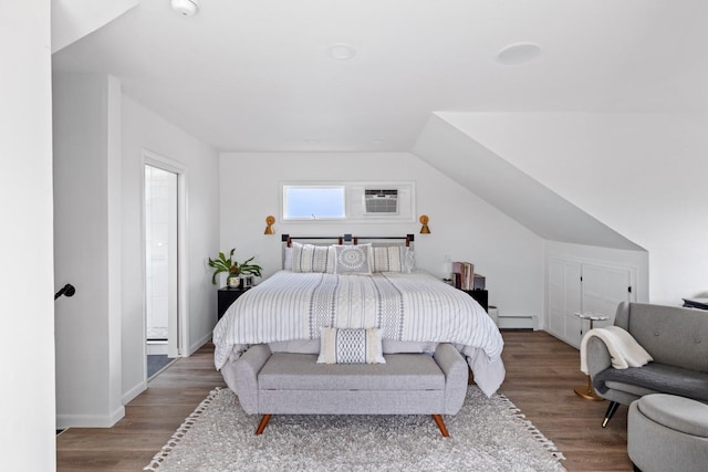 8 The Fairway, Oak Beach, NY 11702 - bedroom featuring a baseboard heating unit and wood finished floors