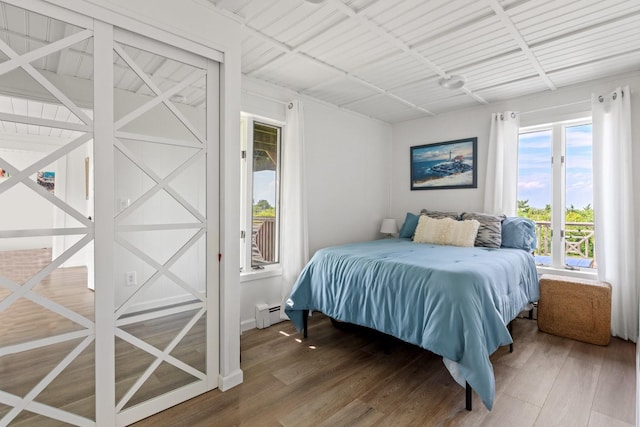 8 The Fairway, Oak Beach, NY 11702 - bedroom with wood finished floors and a baseboard heating unit