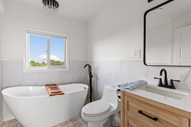 8 The Fairway, Oak Beach, NY 11702 - bathroom with a freestanding bath, vanity, wainscoting, and tile walls
