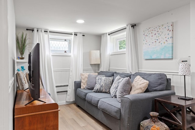 8 The Fairway, Oak Beach, NY 11702 - living area featuring light wood-type flooring, a baseboard heating unit, healthy amount of natural light, and recessed lighting