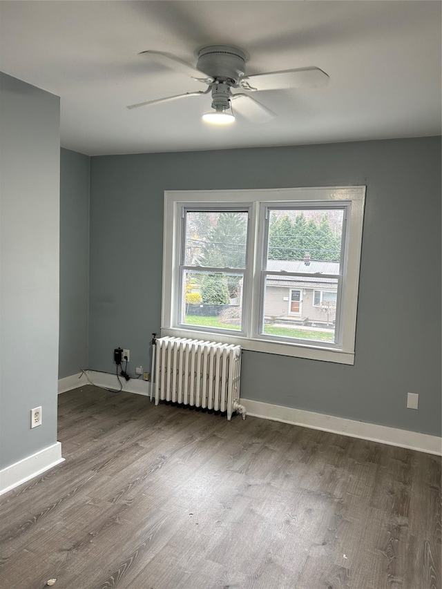 68 Ramapo Rd, Garnerville, NY 10923 - empty room with radiator heating unit, plenty of natural light, a ceiling fan, and wood finished floors