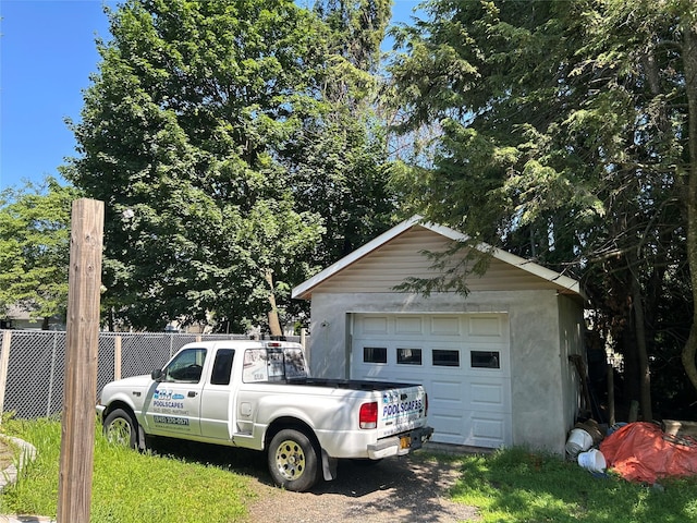 68 Ramapo Rd, Garnerville, NY 10923 - view of side of home featuring an outbuilding, a detached garage, and stucco siding