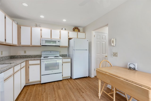 79 Meadow Way, Hopewell Junction, NY 12533 - kitchen featuring white appliances, light countertops, light wood-type flooring, recessed lighting, and white cabinets