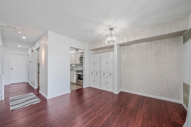 77 Fairview Cir Unit 77, Middle Island, NY 11953 - unfurnished dining area with a chandelier, rail lighting, and wood finished floors