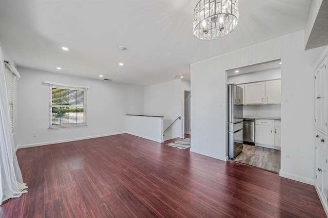 77 Fairview Cir Unit 77, Middle Island, NY 11953 - unfurnished living room with wood finished floors, a chandelier, and recessed lighting