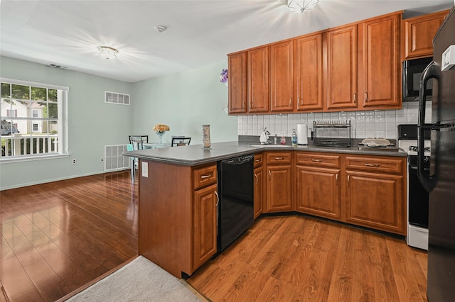 276 Fairview Cir, Middle Island, NY 11953 - kitchen with black appliances, dark countertops, and brown cabinets