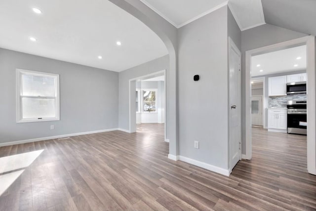 178 N Ocean Ave, Patchogue, NY 11772 - unfurnished living room featuring arched walkways, wood finished floors, and recessed lighting