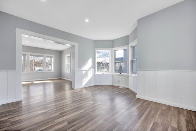 178 N Ocean Ave, Patchogue, NY 11772 - unfurnished living room featuring wood finished floors, wainscoting, recessed lighting, and a decorative wall