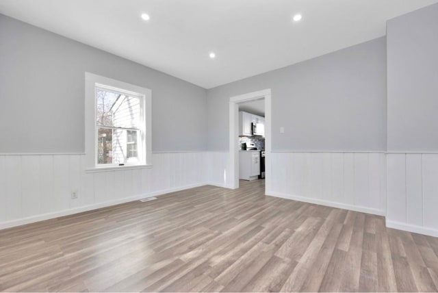 178 N Ocean Ave, Patchogue, NY 11772 - unfurnished room featuring wainscoting, light wood-type flooring, and recessed lighting