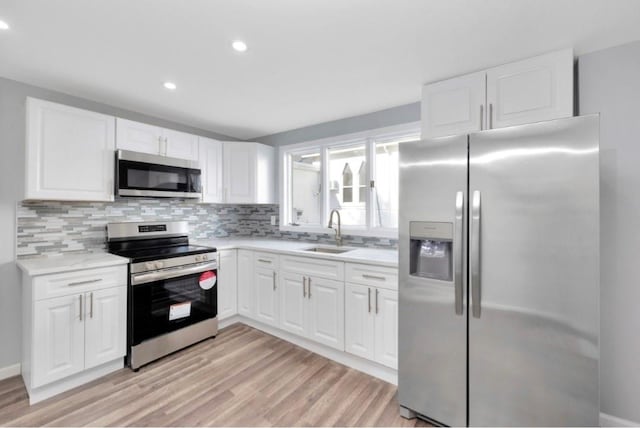 178 N Ocean Ave, Patchogue, NY 11772 - kitchen with stainless steel appliances, tasteful backsplash, light wood-type flooring, light countertops, and recessed lighting
