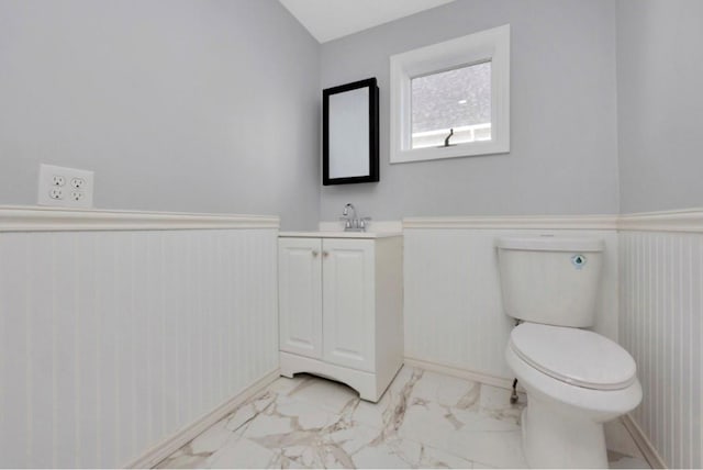 178 N Ocean Ave, Patchogue, NY 11772 - half bathroom featuring vanity, a wainscoted wall, and marble finish flooring