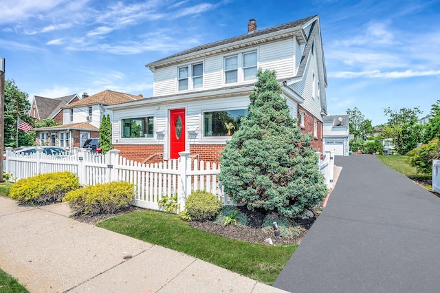 557 Newbridge Rd, East Meadow, NY 11554 - traditional style home with brick siding, a fenced front yard, and a chimney