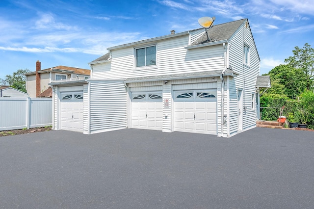 557 Newbridge Rd, East Meadow, NY 11554 - traditional-style house featuring a shingled roof, a garage, and driveway
