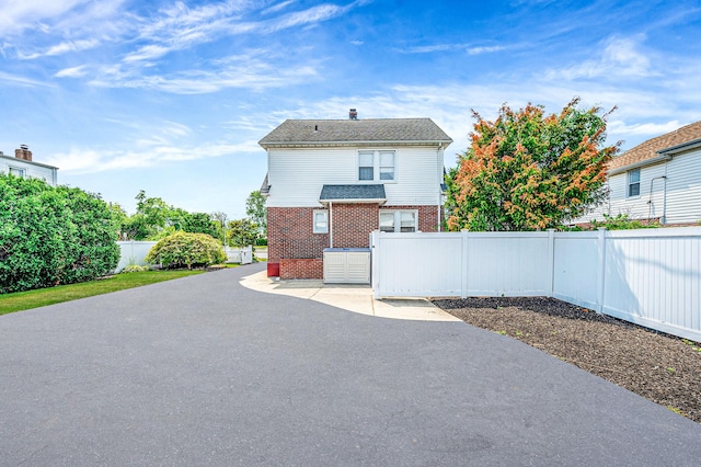 557 Newbridge Rd, East Meadow, NY 11554 - fenced backyard with a patio area