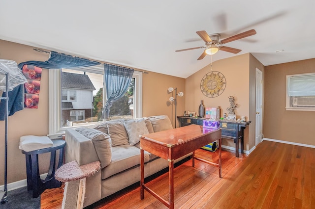 557 Newbridge Rd, East Meadow, NY 11554 - living room featuring wood finished floors, a ceiling fan, healthy amount of natural light, and vaulted ceiling
