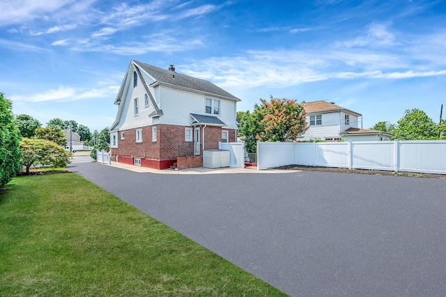 557 Newbridge Rd, East Meadow, NY 11554 - view of side of property featuring brick siding and driveway