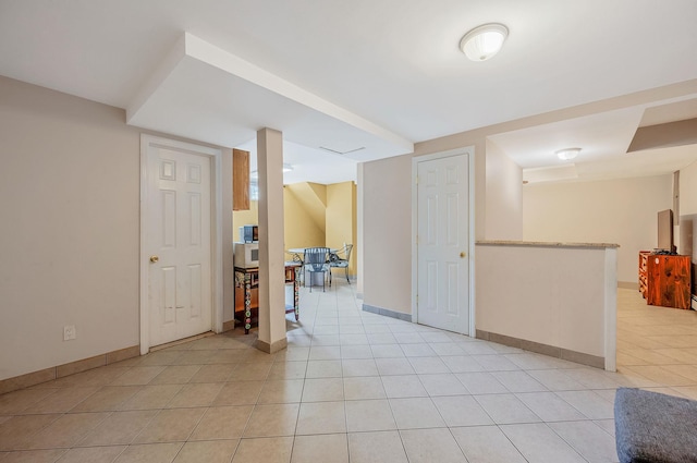 557 Newbridge Rd, East Meadow, NY 11554 - finished below grade area with light tile patterned floors and baseboards
