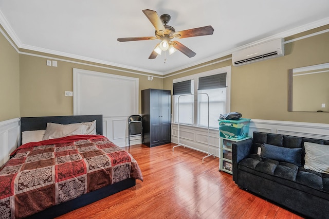 557 Newbridge Rd, East Meadow, NY 11554 - bedroom with a wall mounted AC, ornamental molding, a decorative wall, wood finished floors, and a wainscoted wall