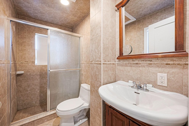 557 Newbridge Rd, East Meadow, NY 11554 - bathroom with tile walls, a stall shower, vanity, and tile patterned floors
