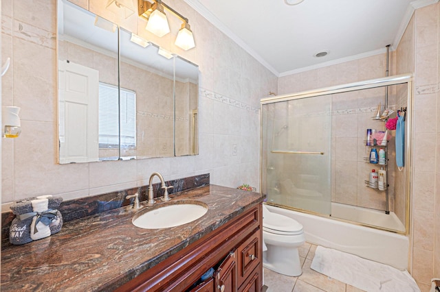557 Newbridge Rd, East Meadow, NY 11554 - full bathroom with vanity, tile walls, bath / shower combo with glass door, tile patterned floors, and ornamental molding