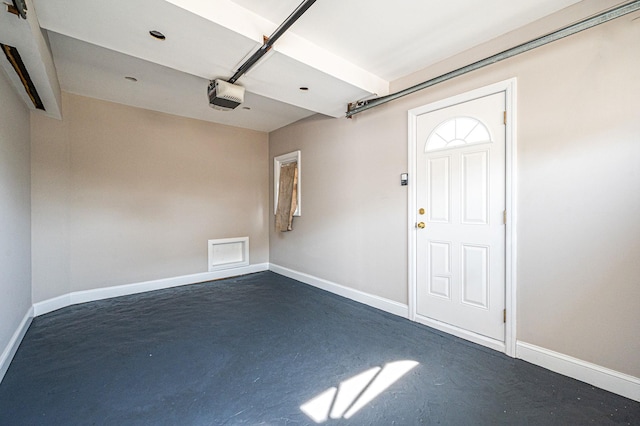 557 Newbridge Rd, East Meadow, NY 11554 - garage featuring a garage door opener and baseboards
