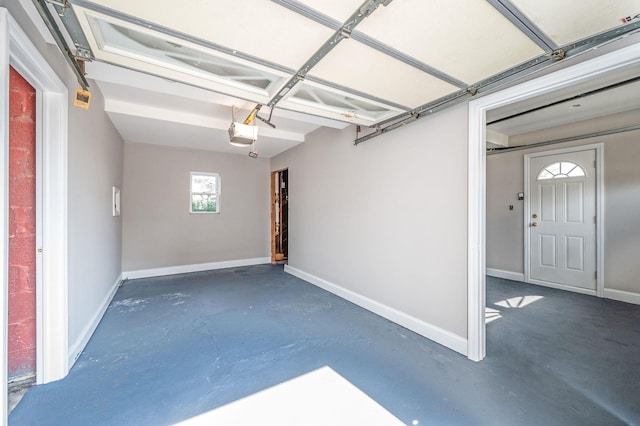 557 Newbridge Rd, East Meadow, NY 11554 - garage with a garage door opener and baseboards
