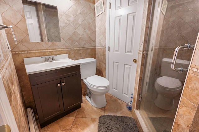 557 Newbridge Rd, East Meadow, NY 11554 - bathroom with a stall shower, vanity, tile walls, and tile patterned floors