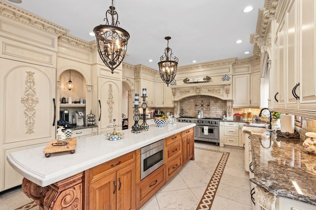 35 Jeffrey Pl, Staten Island, NY 10307 - kitchen featuring appliances with stainless steel finishes, a chandelier, cream cabinetry, a kitchen island, and recessed lighting