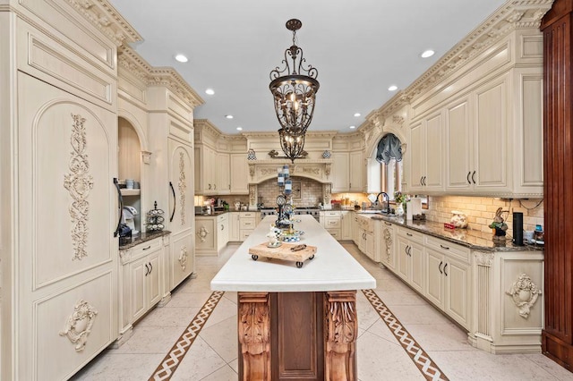 35 Jeffrey Pl, Staten Island, NY 10307 - kitchen with cream cabinets, inlaid floor details, a kitchen island, decorative backsplash, and recessed lighting