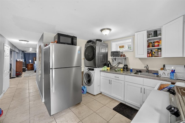 98 N Evarts Ave, Elmsford, NY 10523 - kitchen featuring freestanding refrigerator, stacked washer and clothes dryer, open shelves, light tile patterned flooring, and white cabinets