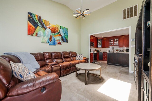 137 Jefferson St, Inwood, NY 11096 - living room featuring wet bar, a chandelier, and high vaulted ceiling