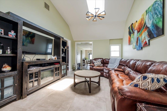 137 Jefferson St, Inwood, NY 11096 - living room with a chandelier, vaulted ceiling, and tile patterned flooring