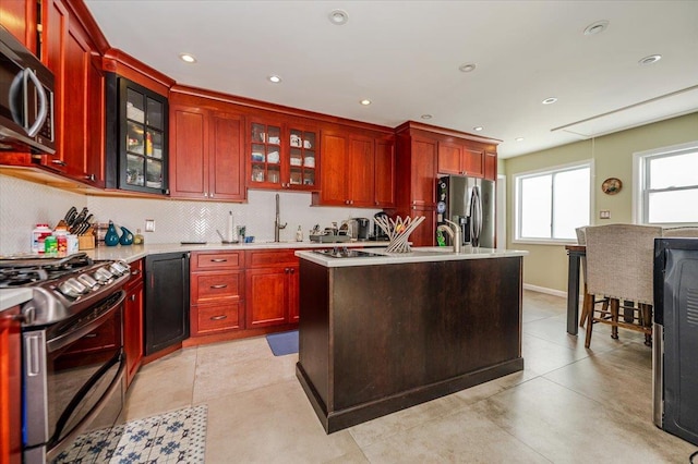 137 Jefferson St, Inwood, NY 11096 - kitchen with stainless steel appliances, reddish brown cabinets, light countertops, and recessed lighting