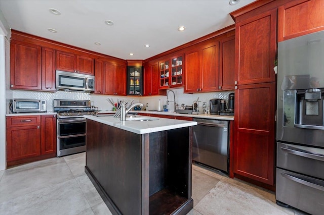 137 Jefferson St, Inwood, NY 11096 - kitchen with stainless steel appliances, reddish brown cabinets, and recessed lighting
