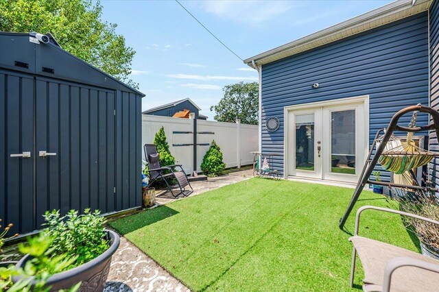 137 Jefferson St, Inwood, NY 11096 - fenced backyard featuring french doors and an outdoor structure