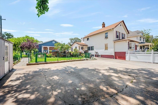 137 Jefferson St, Inwood, NY 11096 - view of side of property with a chimney