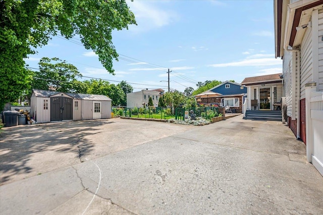 137 Jefferson St, Inwood, NY 11096 - view of patio featuring a shed and concrete driveway