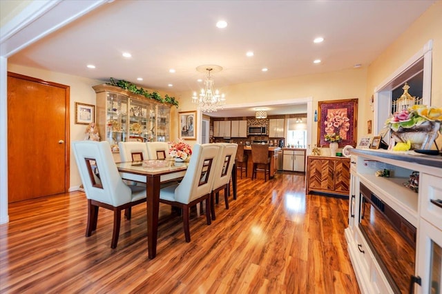 137 Jefferson St, Inwood, NY 11096 - dining area featuring wood finished floors, recessed lighting, and a chandelier