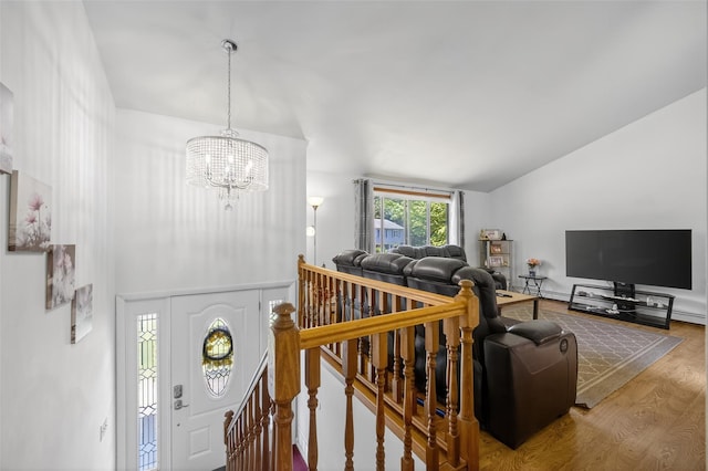 49 Raker Rd, Poughkeepsie, NY 12603 - foyer featuring wood finished floors, a chandelier, and vaulted ceiling