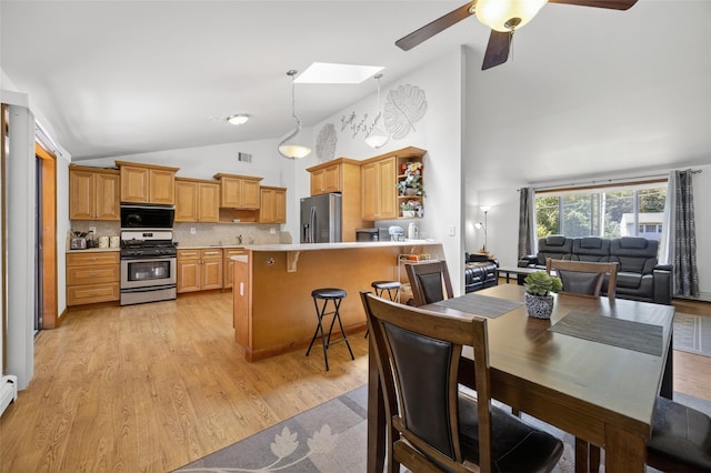 49 Raker Rd, Poughkeepsie, NY 12603 - dining room featuring light wood-style flooring, ceiling fan, a skylight, high vaulted ceiling, and a baseboard heating unit