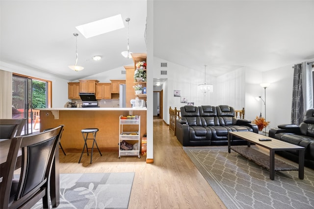49 Raker Rd, Poughkeepsie, NY 12603 - living room featuring light wood finished floors, a chandelier, a skylight, and high vaulted ceiling