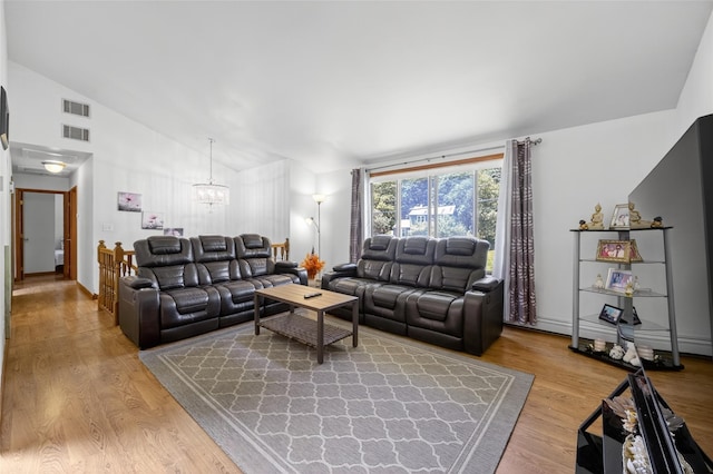 49 Raker Rd, Poughkeepsie, NY 12603 - living area featuring a chandelier, light wood finished floors, and high vaulted ceiling