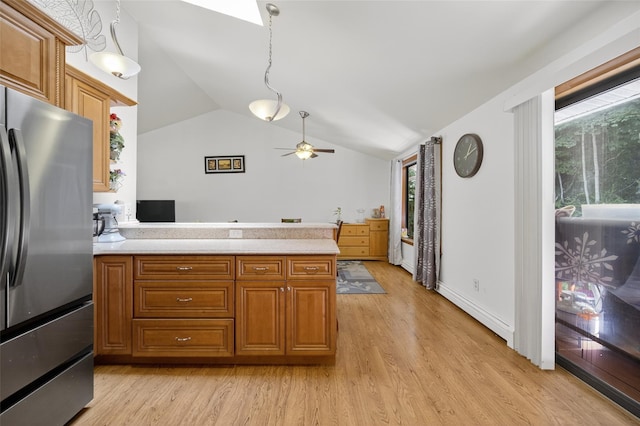 49 Raker Rd, Poughkeepsie, NY 12603 - kitchen featuring freestanding refrigerator, light countertops, brown cabinets, light wood-style flooring, and lofted ceiling