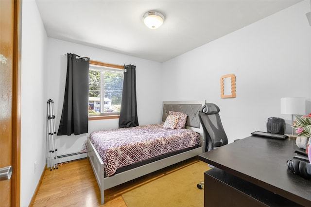 49 Raker Rd, Poughkeepsie, NY 12603 - bedroom featuring a baseboard radiator, light wood-style floors, and an office area