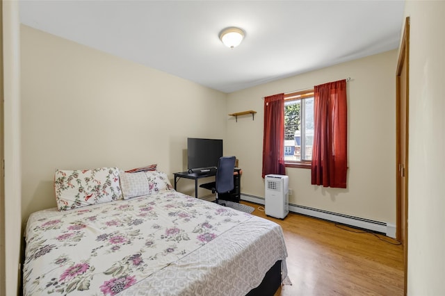49 Raker Rd, Poughkeepsie, NY 12603 - bedroom featuring baseboard heating and wood finished floors