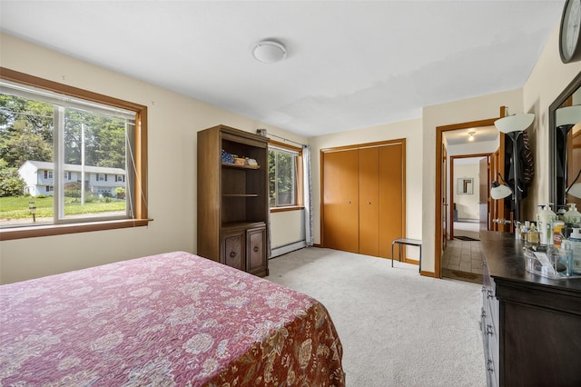 49 Raker Rd, Poughkeepsie, NY 12603 - bedroom with light colored carpet, a baseboard radiator, and a closet